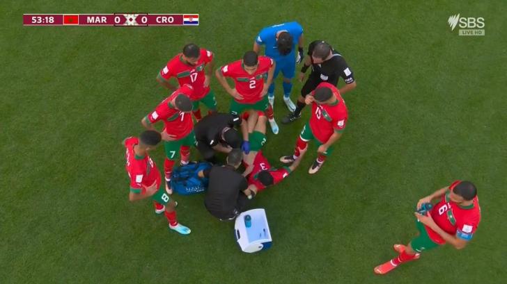Mazraoui gets treatment during a lengthy delay.