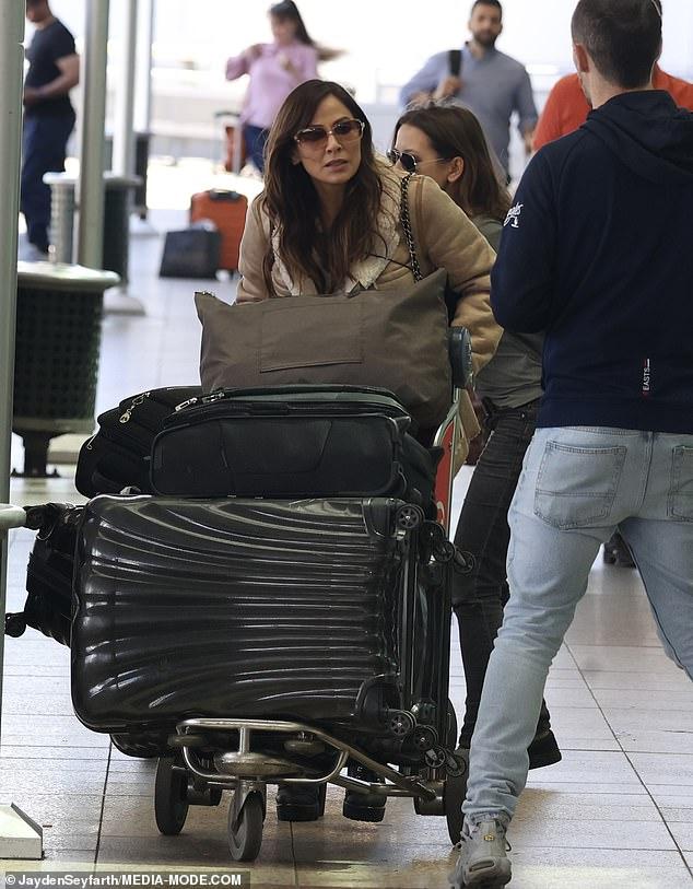 Pushing a trolley stacked with half-a-dozen pieces of luggage, including suit cases and travel bags, the Torn star looked determined to make her way through the crowded terminal
