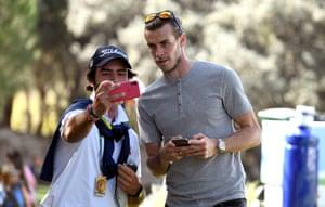 Bale poses with a fan at a golf tournament in Madrid in 2019.