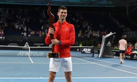 Novak Djokovic celebrates with the trophy after winning the Adelaide International against Sebastian Korda