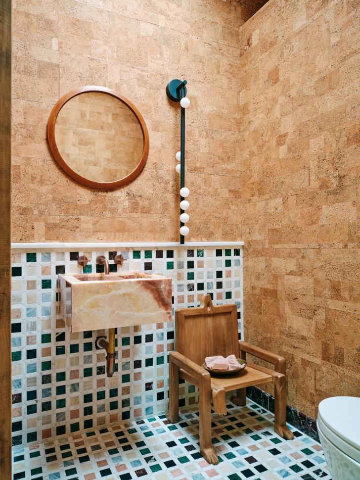 Bathroom with bright tiles and wooden chair