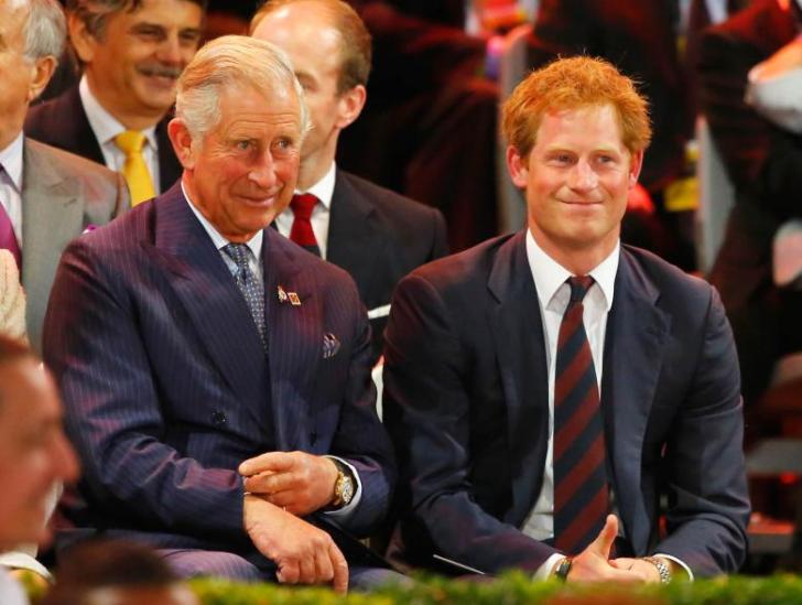 King Charles III and Prince Harry sitting next to each other at an event.
