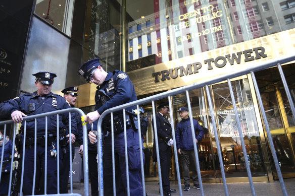 Police officers place a barricade in front of Trump Tower in New York on Tuesday.