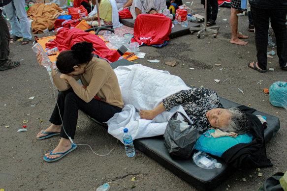 Earthquake survivors are treated outside a hospital in Cianjur, West Java.